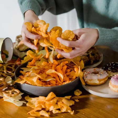 Mani con cibo spezzettato e ciotola, simbolo della frammentazione e del conflitto con l'alimentazione, consulenza per